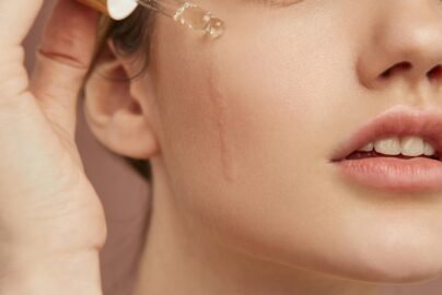 close up smiley woman using serum 1