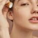 close up smiley woman using serum 1