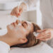 cosmetologist doing face treatment applying face mask