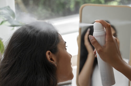 person using dry shampoo